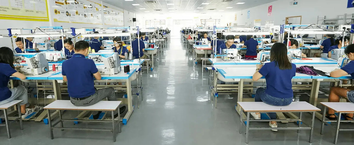 Workers sewing at modern manufacturing facility creating ruffled bowknot mini summer dress