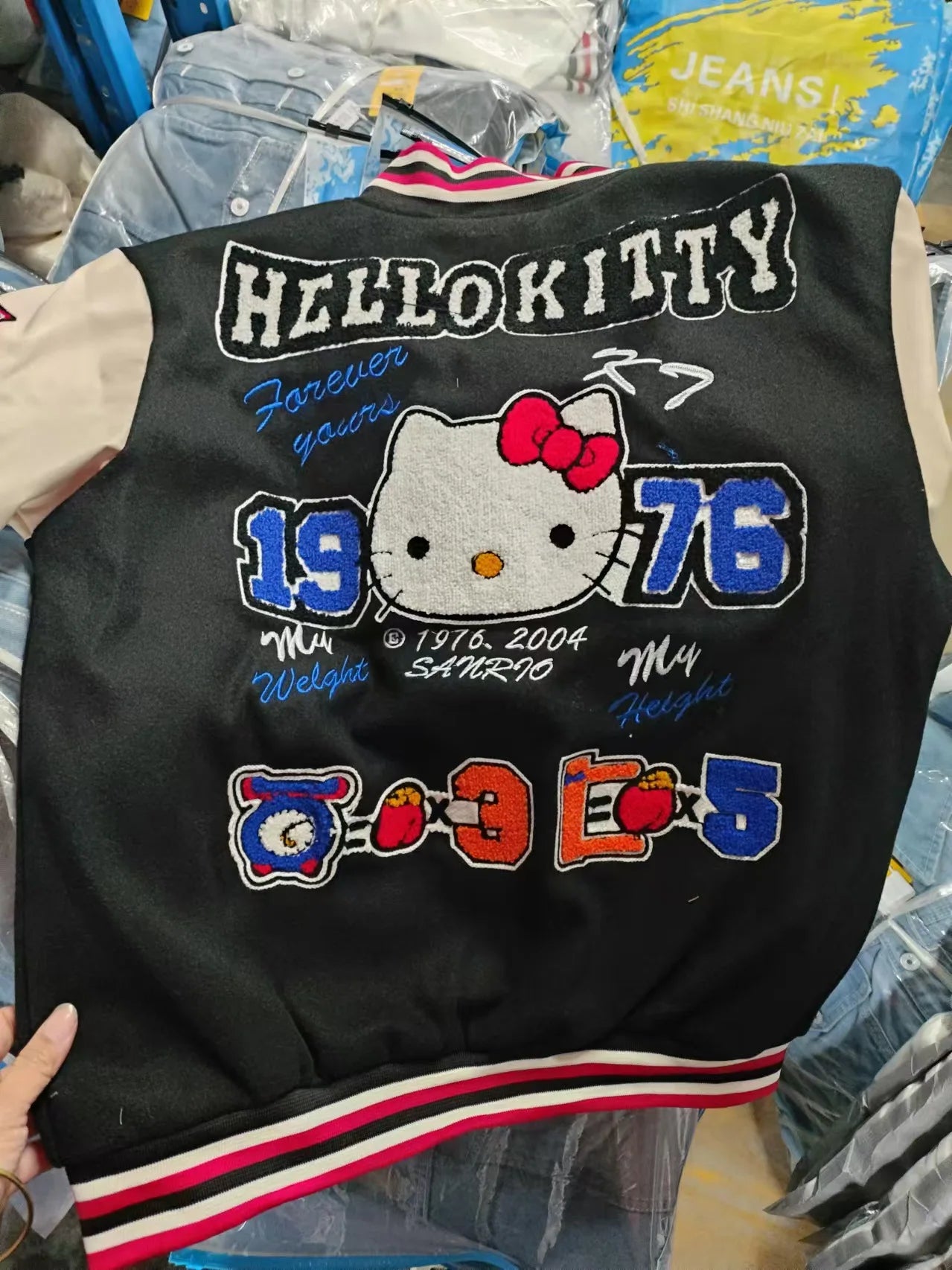 Hello Kitty baseball jacket black varsity style back view with large embroidered Hello Kitty 1976 patches