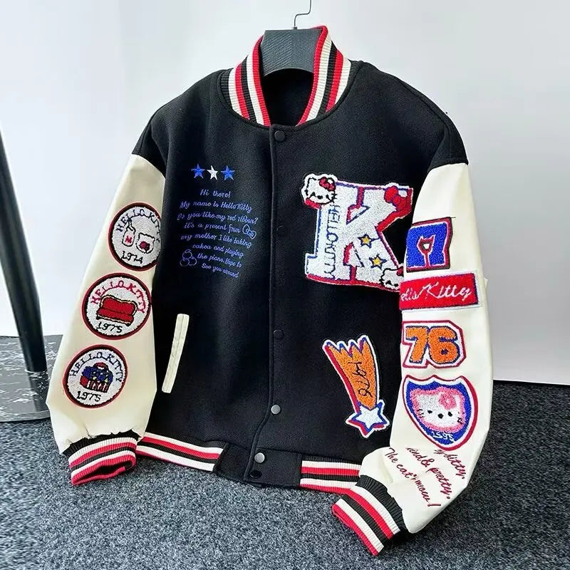 Black and cream varsity style Hello Kitty baseball jacket with embroidered patches and red striped trim