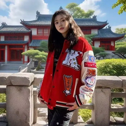Young woman wearing red Hello Kitty baseball jacket with embroidered patches standing by stone railing in front of a temple