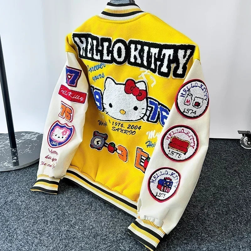 Yellow and white varsity Hello Kitty baseball jacket with large embroidered Hello Kitty on back and multiple colorful patches