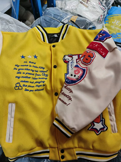 Yellow Hello Kitty baseball jacket with cream sleeves embroidered patches and striped collar