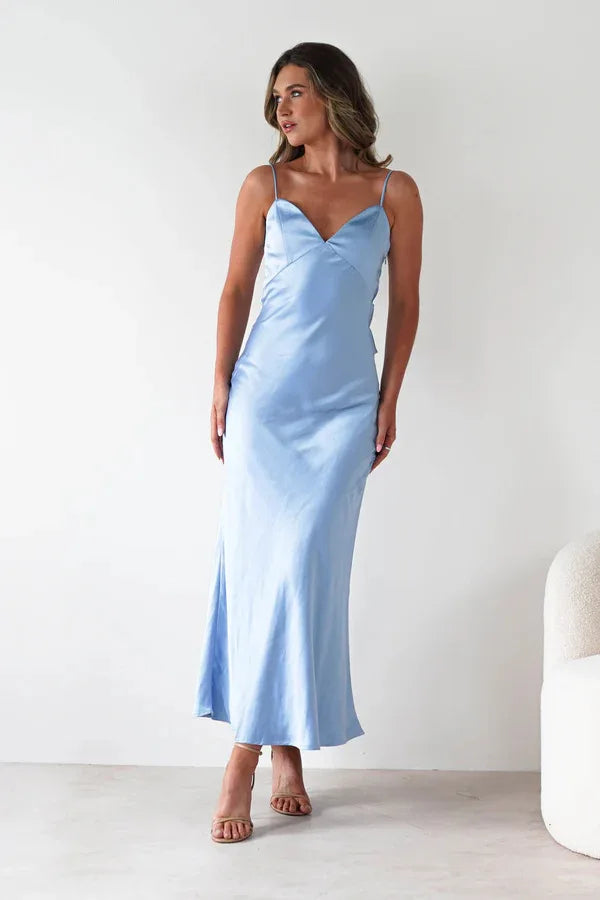 Model wearing a sexy satin halter dress in light blue, showcasing a sleek fit and elegant style