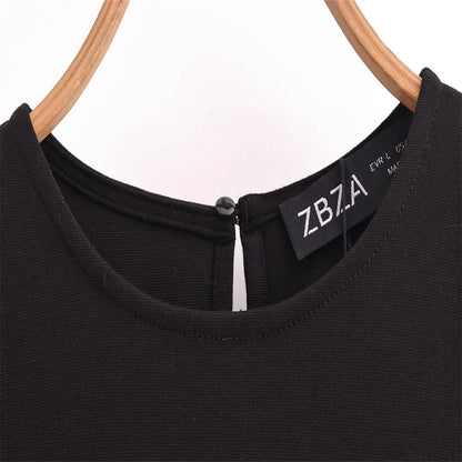 Close-up of a sleeveless chic cocktail dress with a sophisticated neckline and zipper detail
