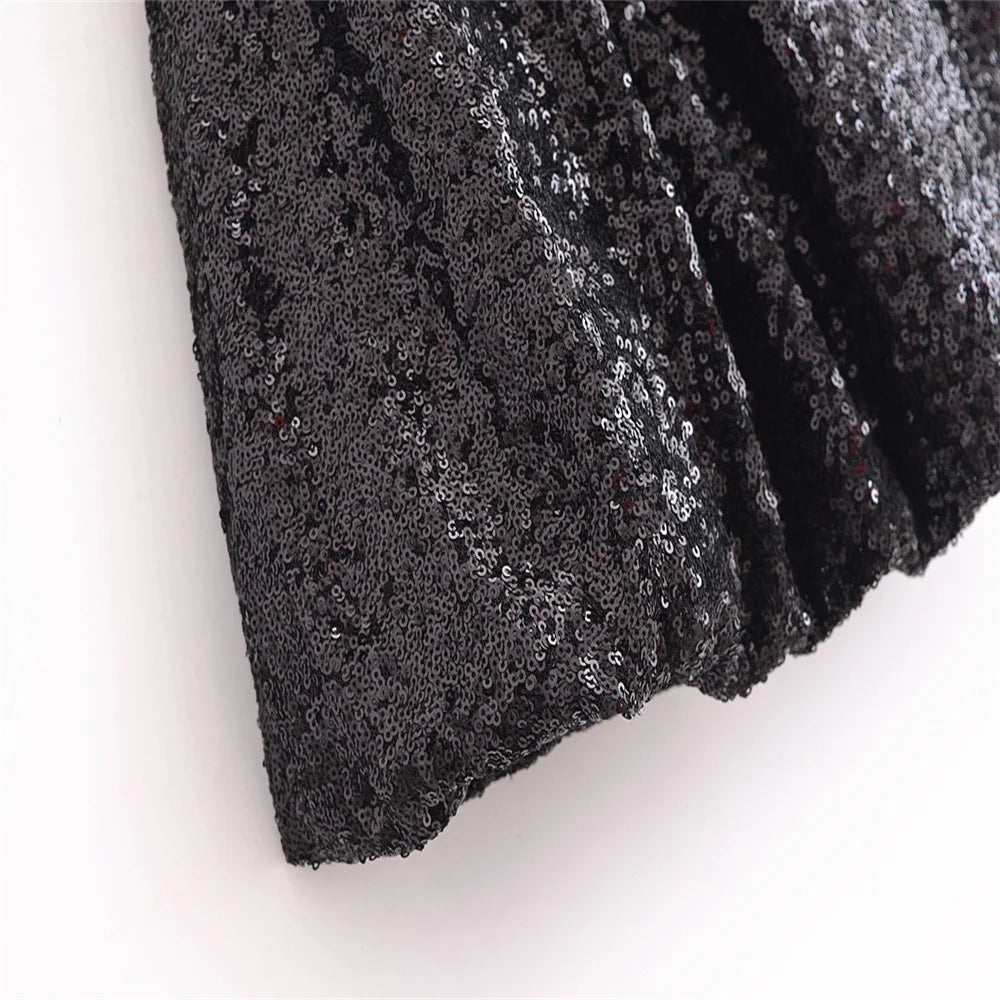 Black sequined sleeveless chic cocktail dress with elegant shimmering design and stylish flare