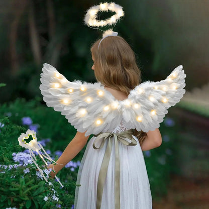 White lighted wings and halo with wand on woman in flowing dress in garden adult fairy wand and halo costume set