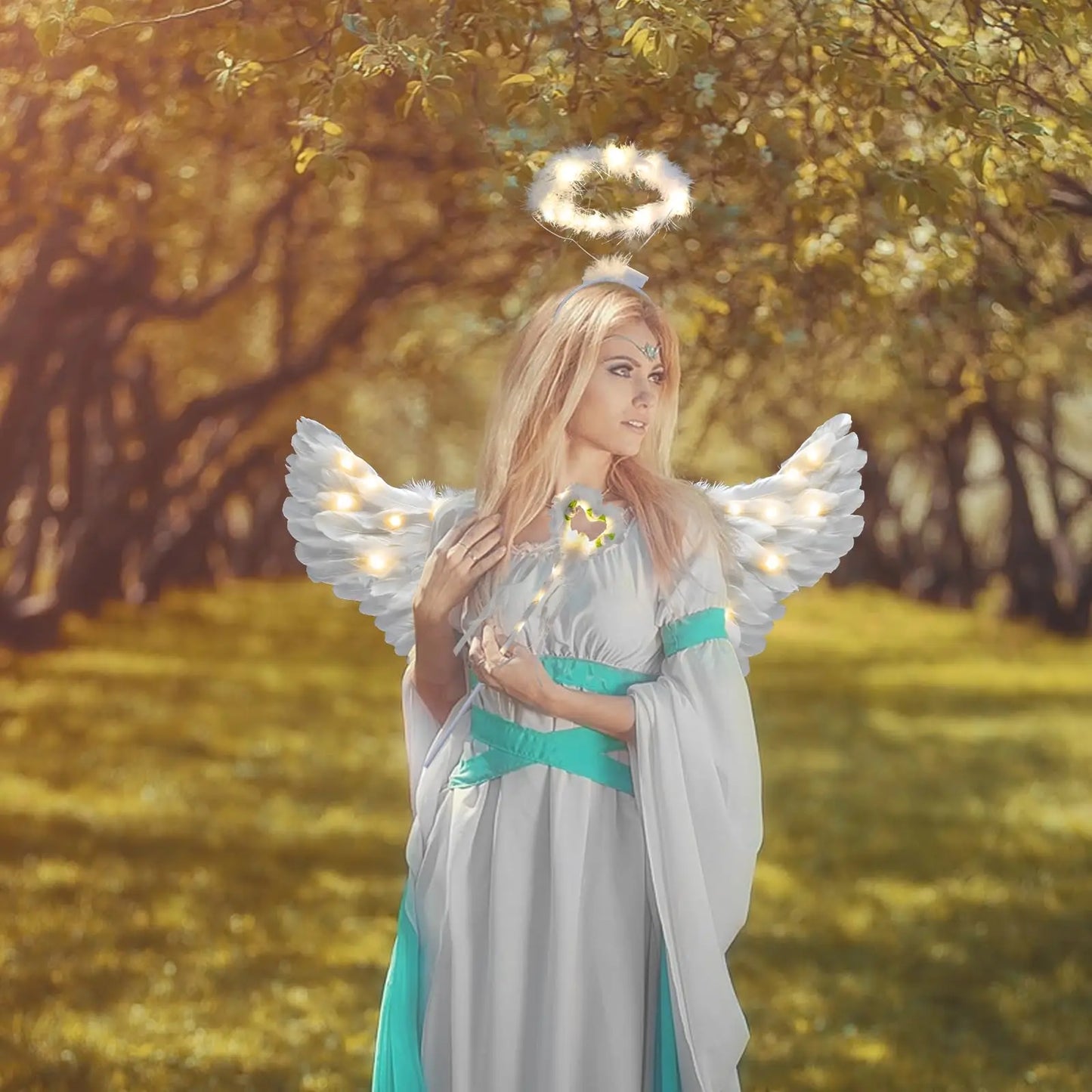 Model in woodland wearing adult fairy wand and halo costume set with illuminated wings and teal gown