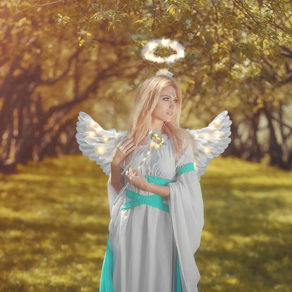 Model in woodland wearing adult fairy wand and halo costume set with illuminated wings and teal gown