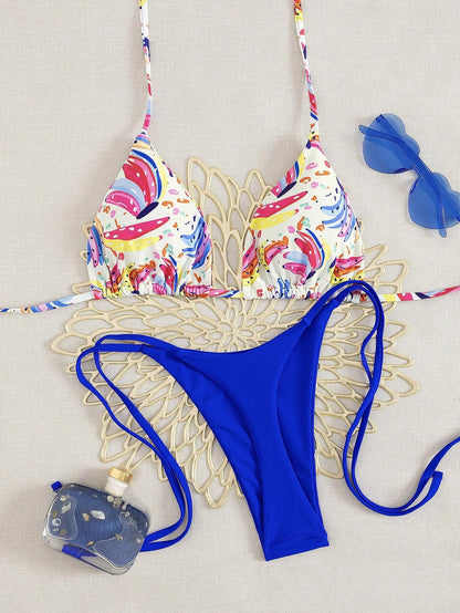 EtherealBe tropical fruit print bikini set with multicolor triangle top and cobalt blue tie side bottoms with sunglasses