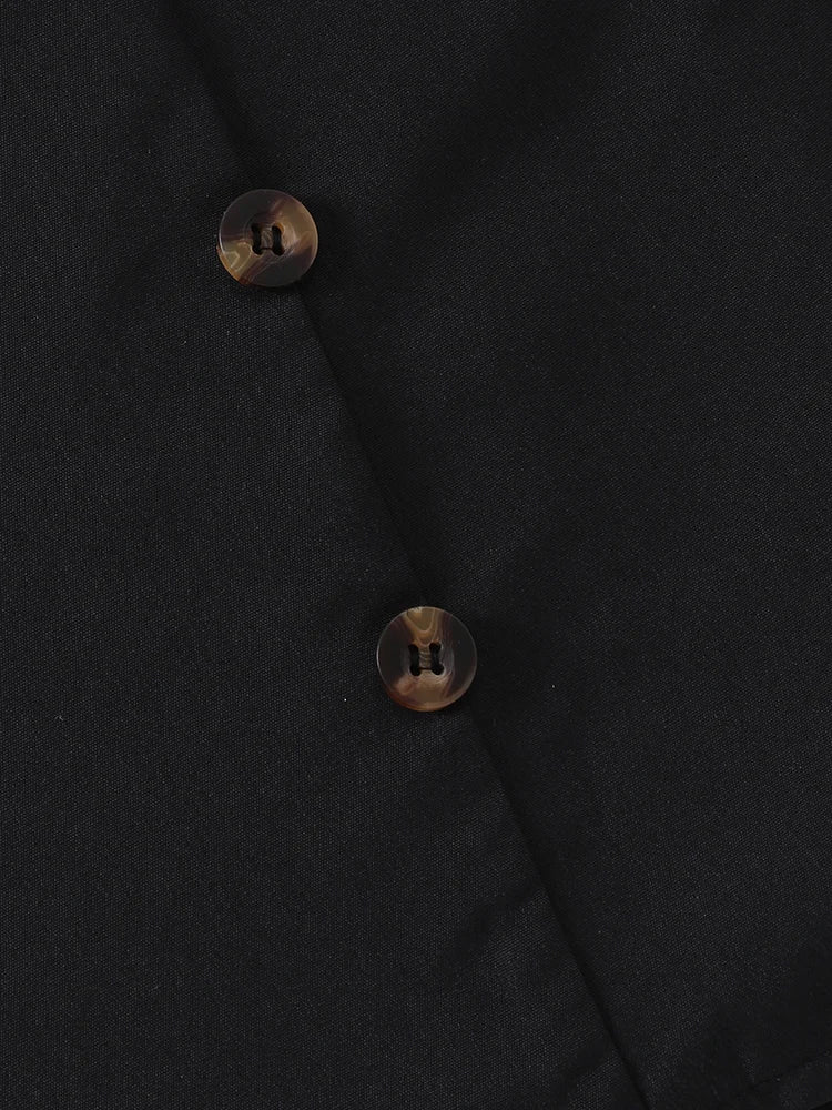 Close-up of EtherealBe sweet ruffle long sleeve top and skirt in black featuring stylish buttons