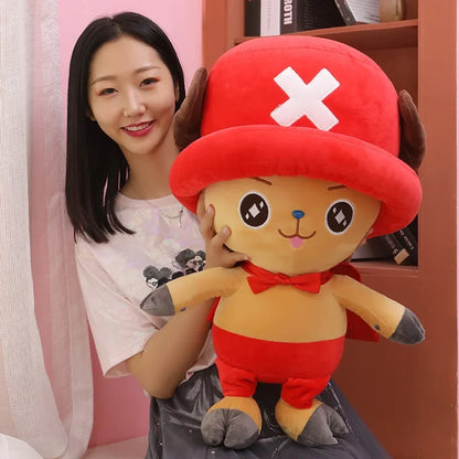 Cute Tony Tony Chopper plush doll held by a smiling woman in a cozy room
