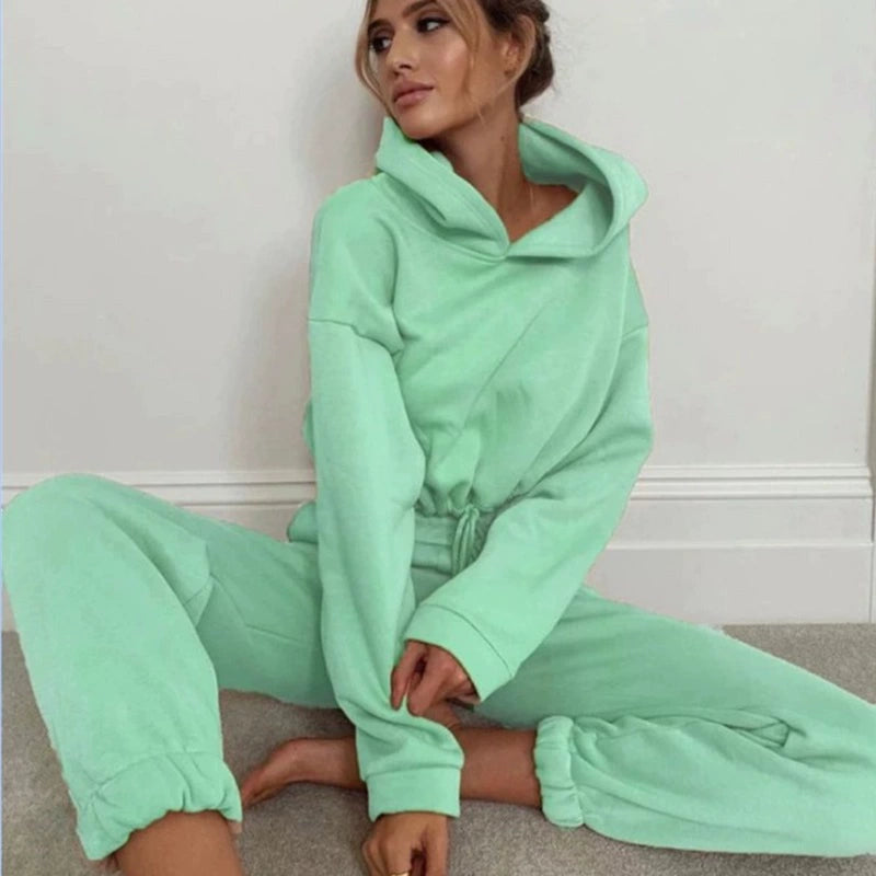 Stylish woman wearing a trendy women's hoodie and joggers set in mint green color for casual comfort