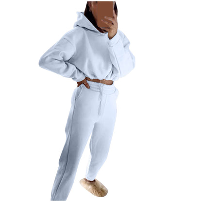 Stylish model wearing a trendy women's hoodie and joggers set in soft white fabric