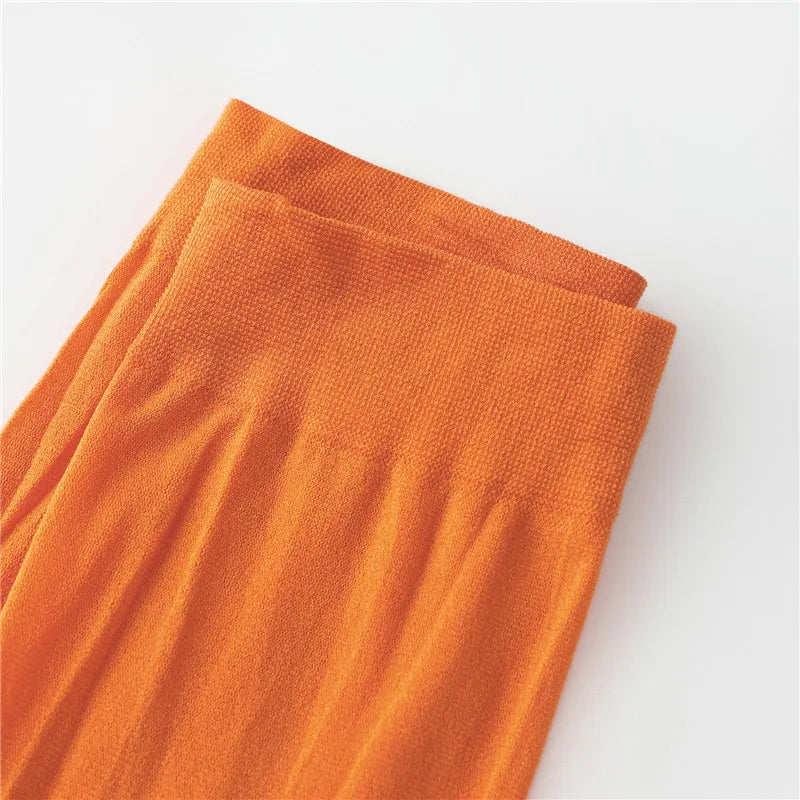 Close-up of bright orange leggings for women, perfect for a Velma costume for women