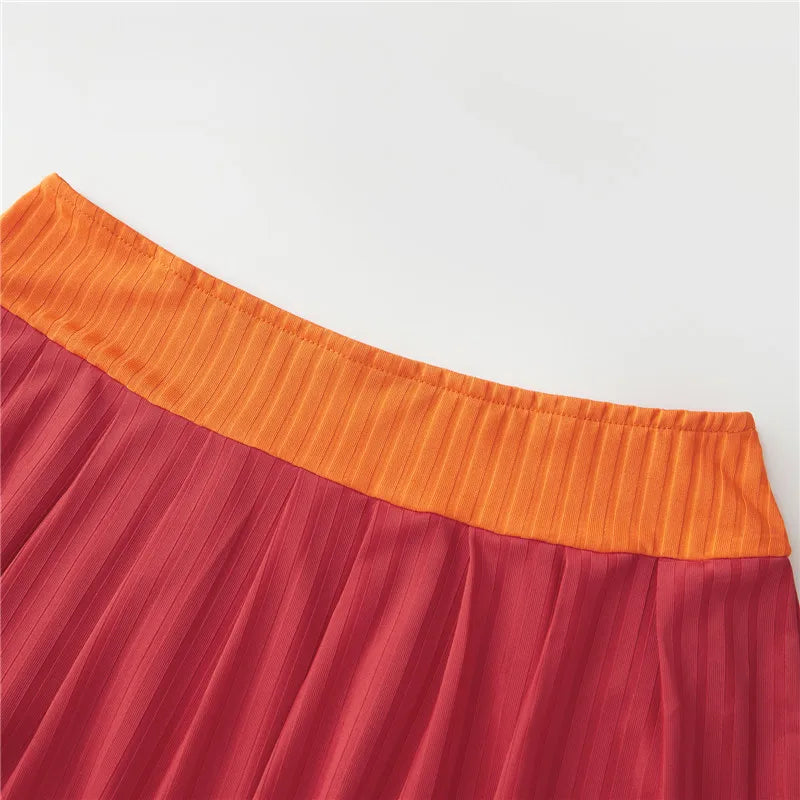 EtherealBe Velma costume for women featuring a vibrant orange and red pleated skirt
