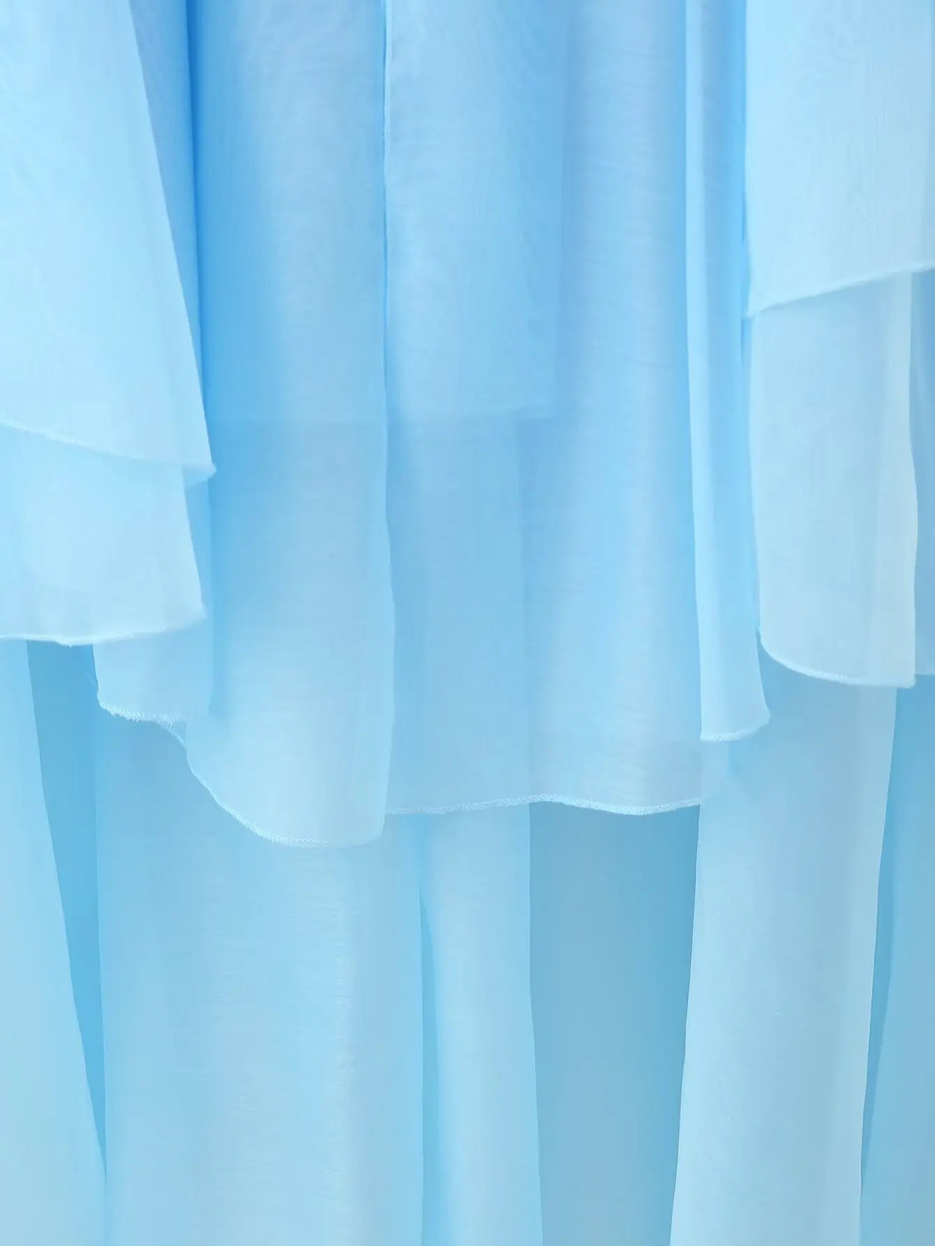 EtherealBe elegant layered decorative dress in soft blue with flowing fabric layers