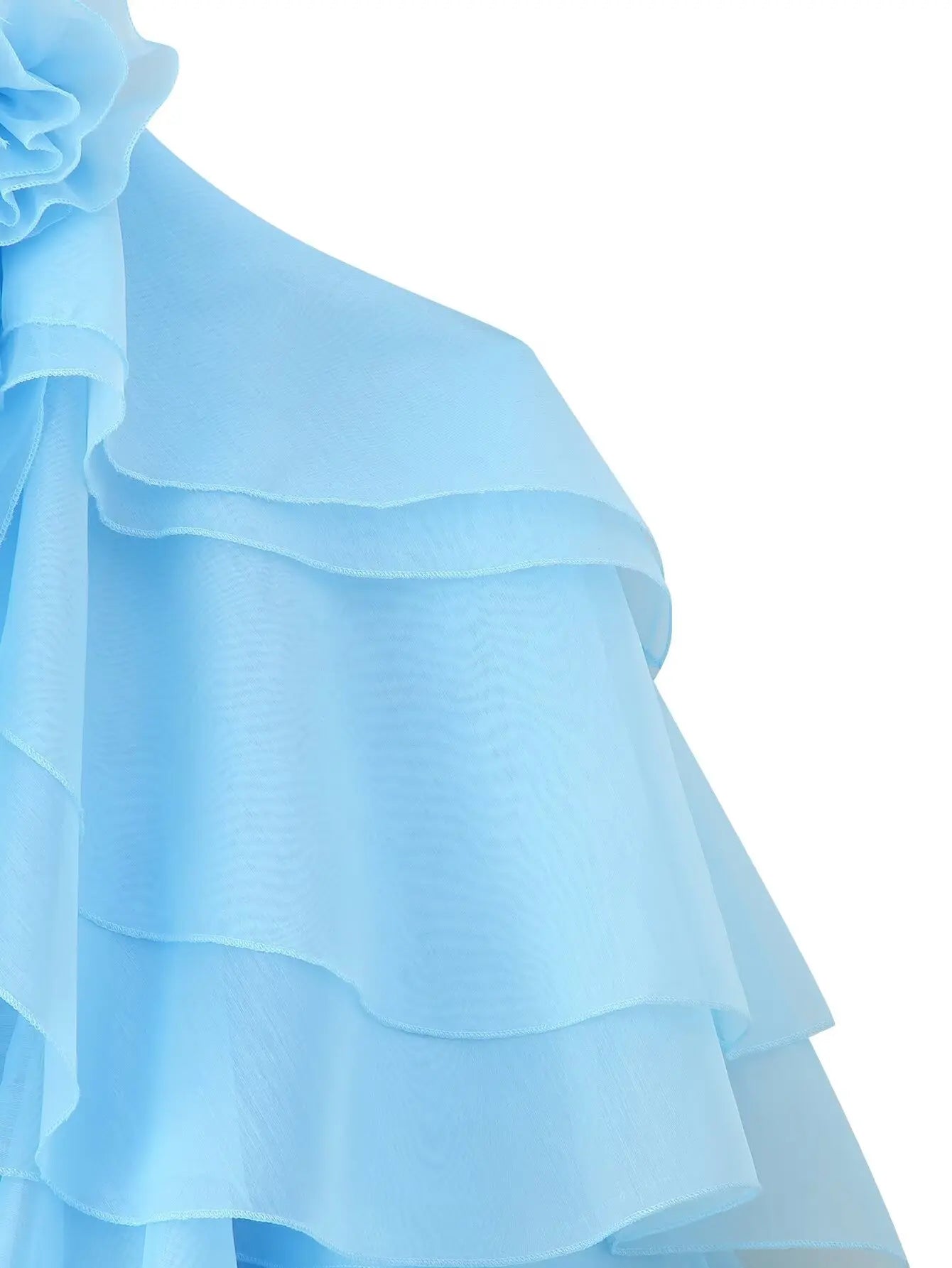 Close-up of an elegant layered decorative dress in soft blue with ruffled details