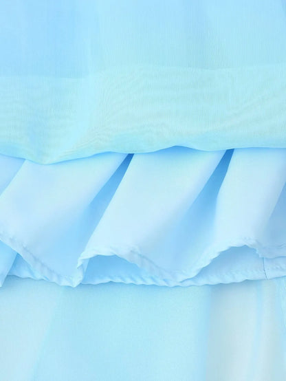 Close-up of elegant layered decorative dress in light blue showcasing ruffled fabric layers