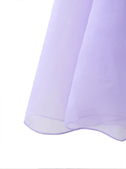 Close-up of the elegant layered decorative dress in soft purple fabric flowing gracefully