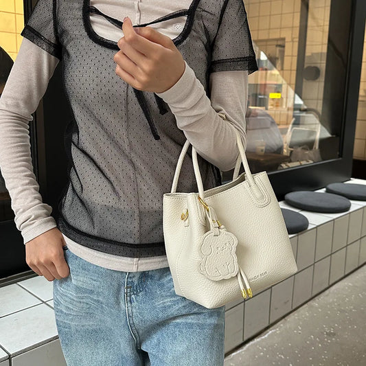 EtherealBe stylish handbag displayed with a sheer top, ideal for fashionable work bags for women