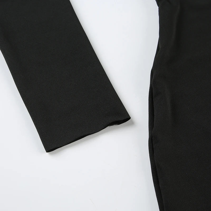Close up of black long sleeve mini dress showing fitted side seam and smooth stretch fabric on white background