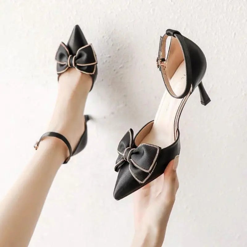 Elegant black stiletto heels with a bow detail, perfect for chic evening wear