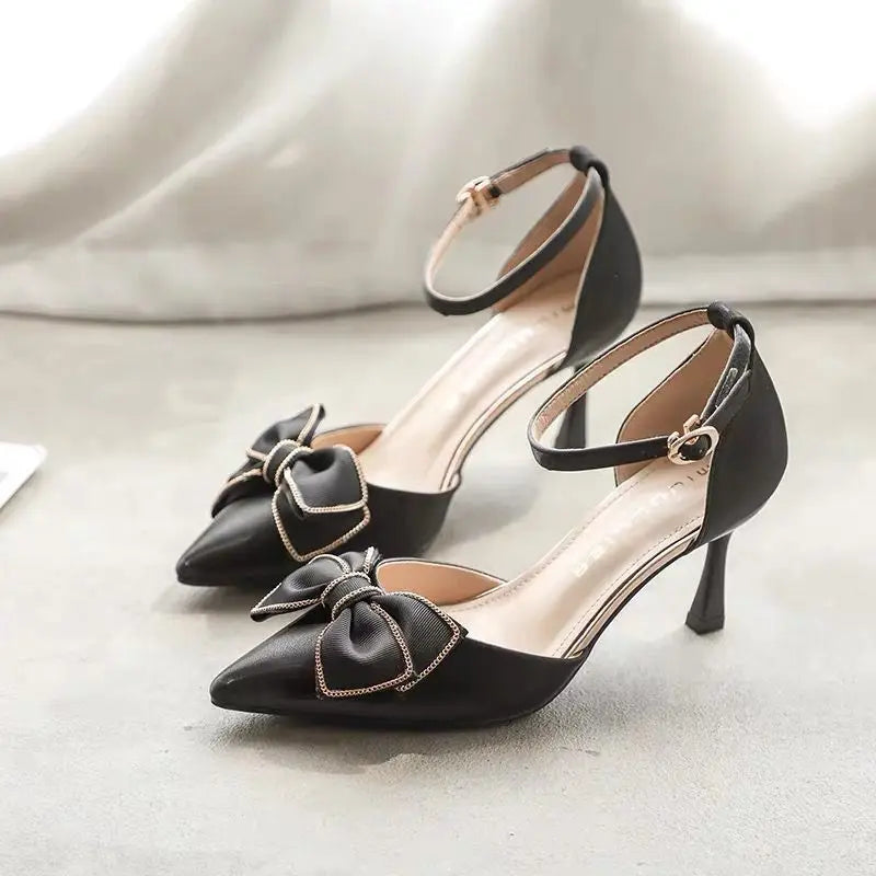 Elegant black stiletto heels with bow detail, perfect for pairing with formal outfits