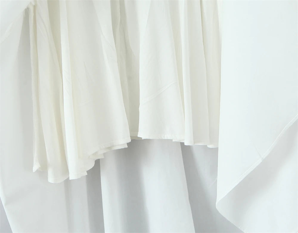 Close-up view of a white lace panel midi dress for women showcasing textured fabric and elegant design