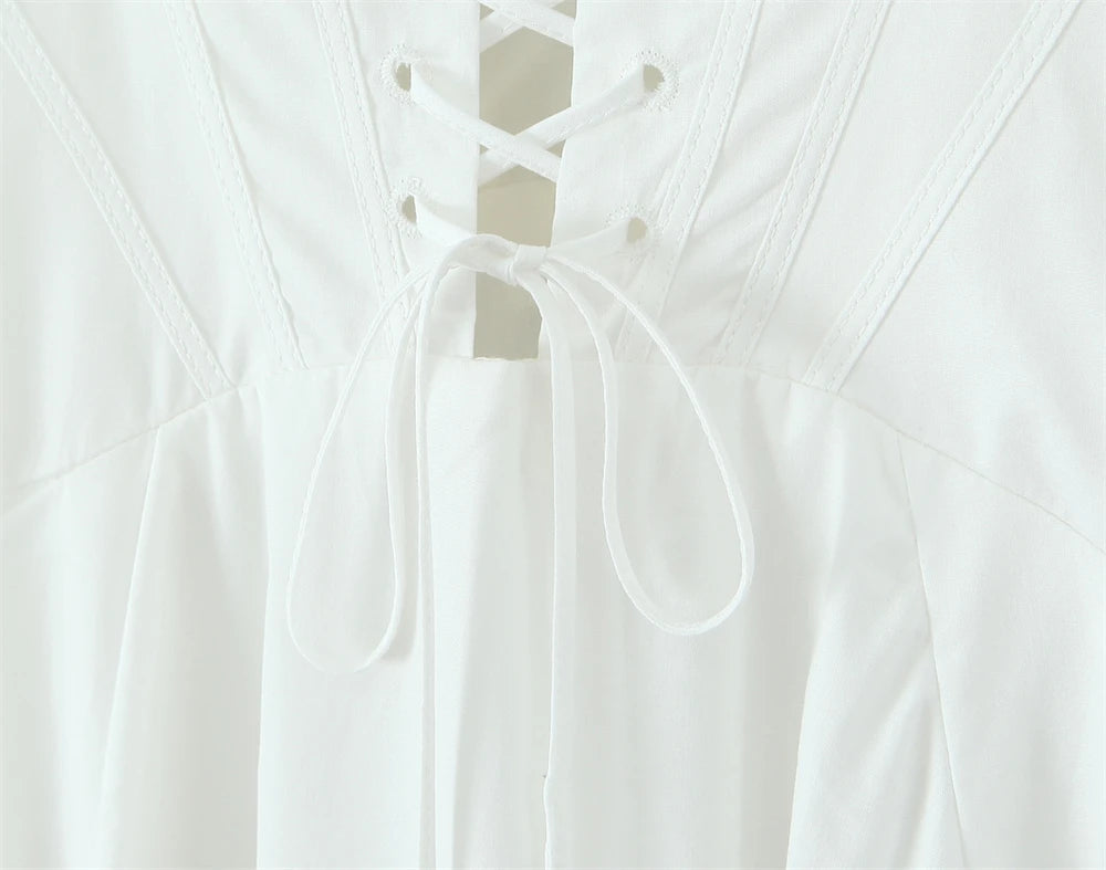 Back view of a white lace panel midi dress for women with intricate lace detailing and tie closure