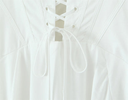 Back view of a white lace panel midi dress for women with intricate lace detailing and tie closure
