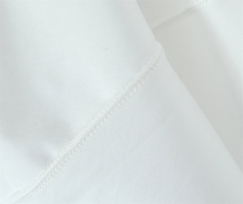 Close-up of fabric texture showing stitching on a white lace panel midi dress for women