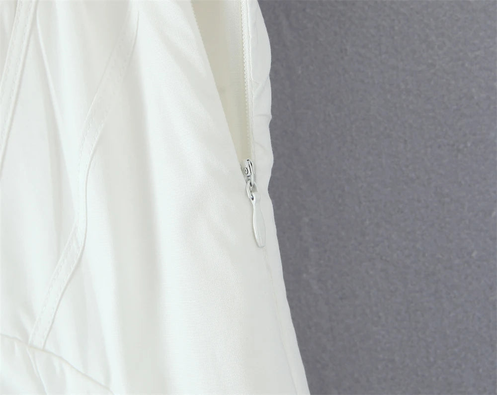Close-up of white lace panel midi dress for women showcasing zipper detail and elegant design