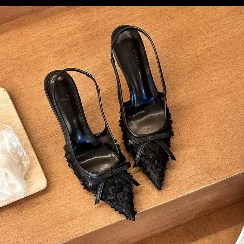 Elegant black lace slingback heels for women with pointed toe and delicate bow detail