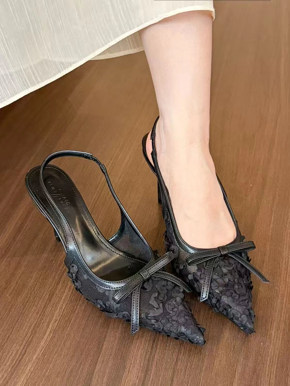 Black lace slingback heels for women with elegant bow detail, perfect for formal occasions