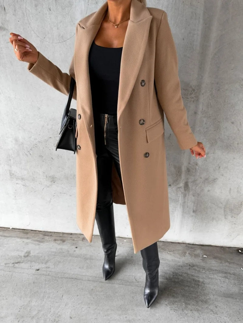 Stylish women's double-breasted wool coat in beige, worn with black pants and high-heeled boots