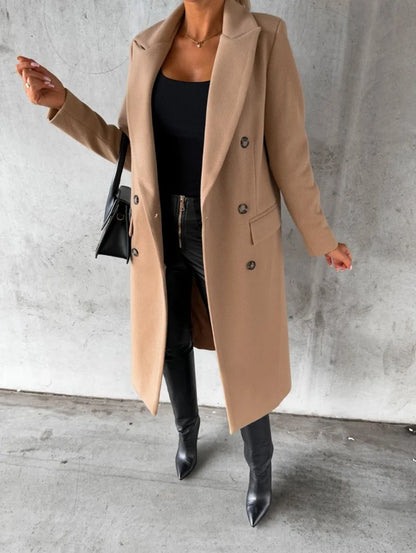 Stylish women's double-breasted wool coat in beige, worn with black pants and high-heeled boots