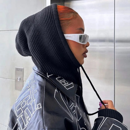 Trendy black knit pullover balaclava for women styled with futuristic sunglasses and a jacket