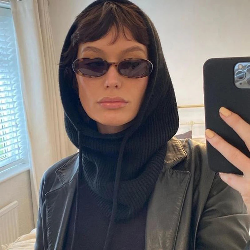 Stylish woman in sunglasses wearing a knit pullover balaclava for women with a chic black outfit