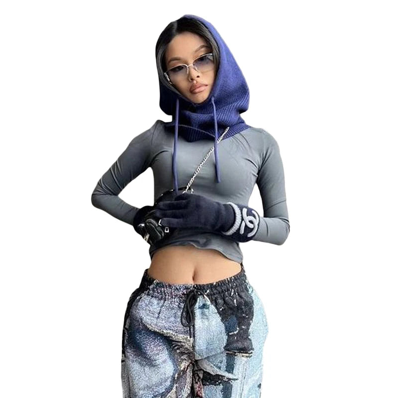 Stylish woman wearing a knit pullover balaclava for women, paired with a fitted top and pants