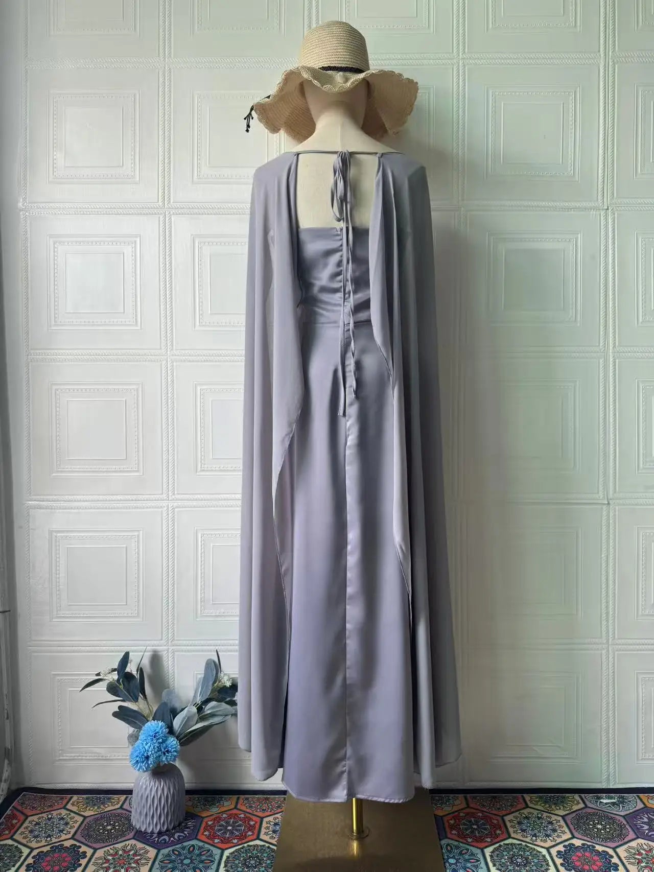 Elegant women's fairy style formal gown in soft gray with flowing cape detail