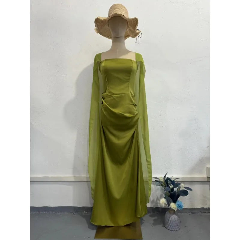 Ethereal women's fairy style formal gown in vibrant green with flowing sleeves and elegant silhouette