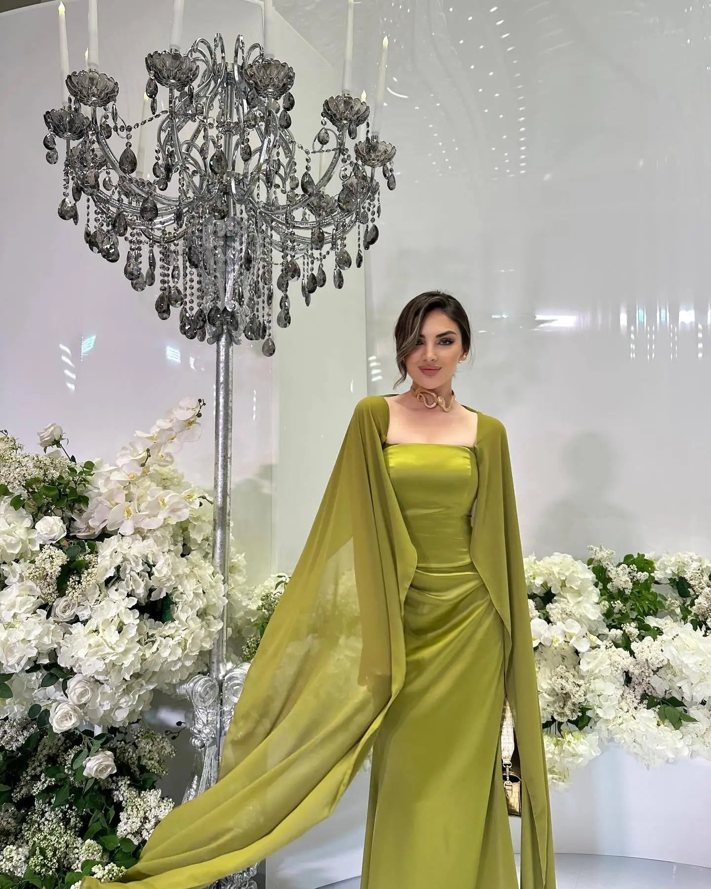 Elegant women's fairy style formal gown in green with flowing cape sleeves for special events