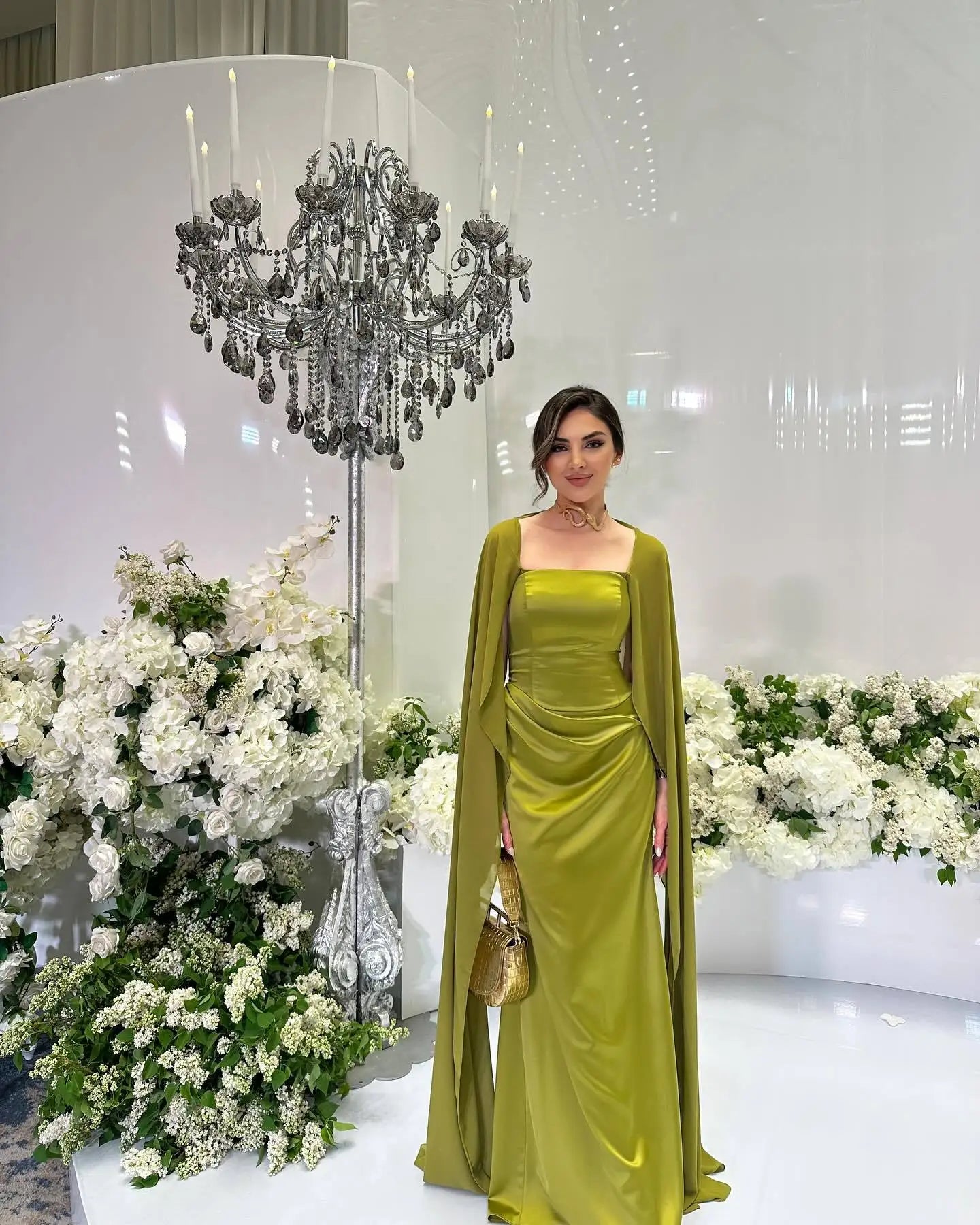 EtherealBe women's fairy style formal gown in vibrant green with elegant cape detail and floral backdrop