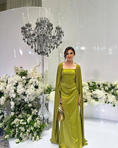 EtherealBe women's fairy style formal gown in vibrant green with elegant cape detail and floral backdrop