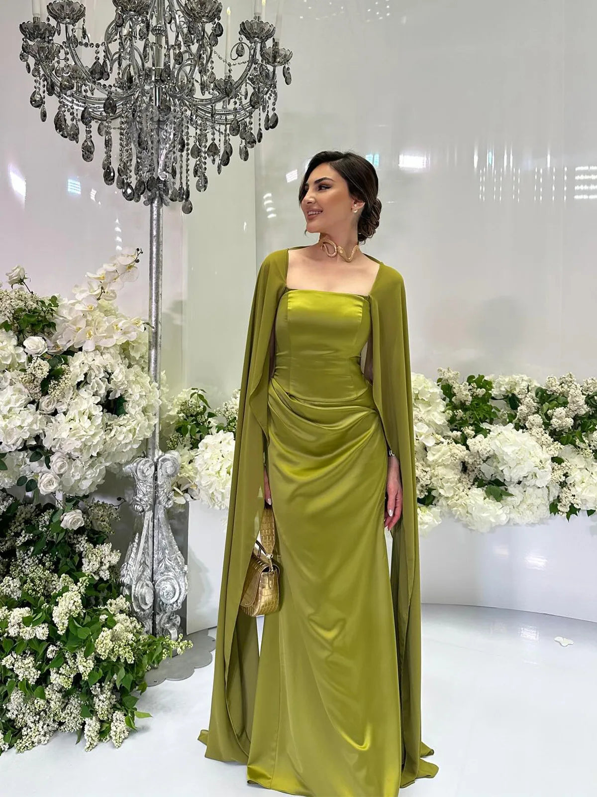 Elegant women's fairy style formal gown in olive green with flowing cape and a sophisticated silhouette