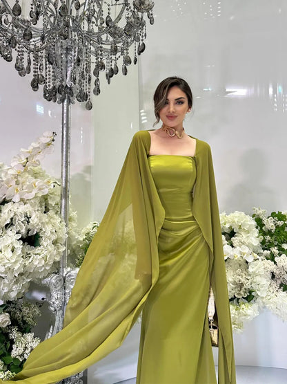 Elegant women's fairy style formal gown in olive green with flowing cape and fitted silhouette