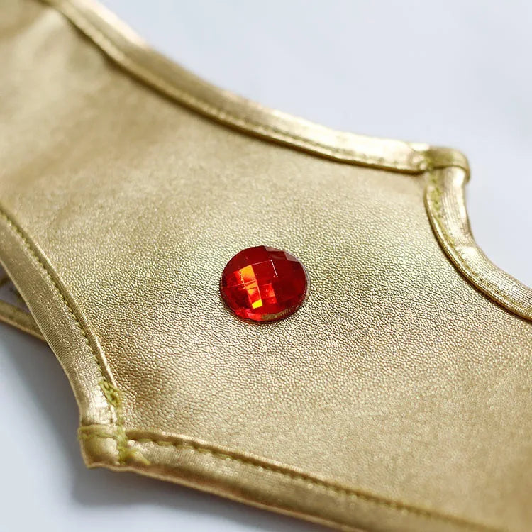 Close-up of the gold detail on an EtherealBe Wonder Woman cosplay costume featuring a red gem accessory