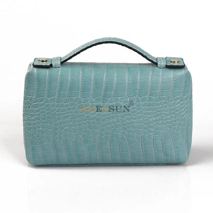 EtherealBe luxurious faux crocodile makeup bag in teal with a stylish handle and textured design