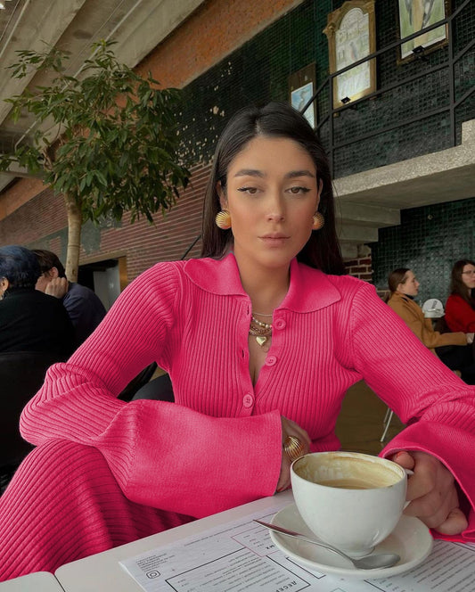 Woman in bright pink ribbed lounge set with button collar and wide sleeves sipping coffee trendy lounge sets for women