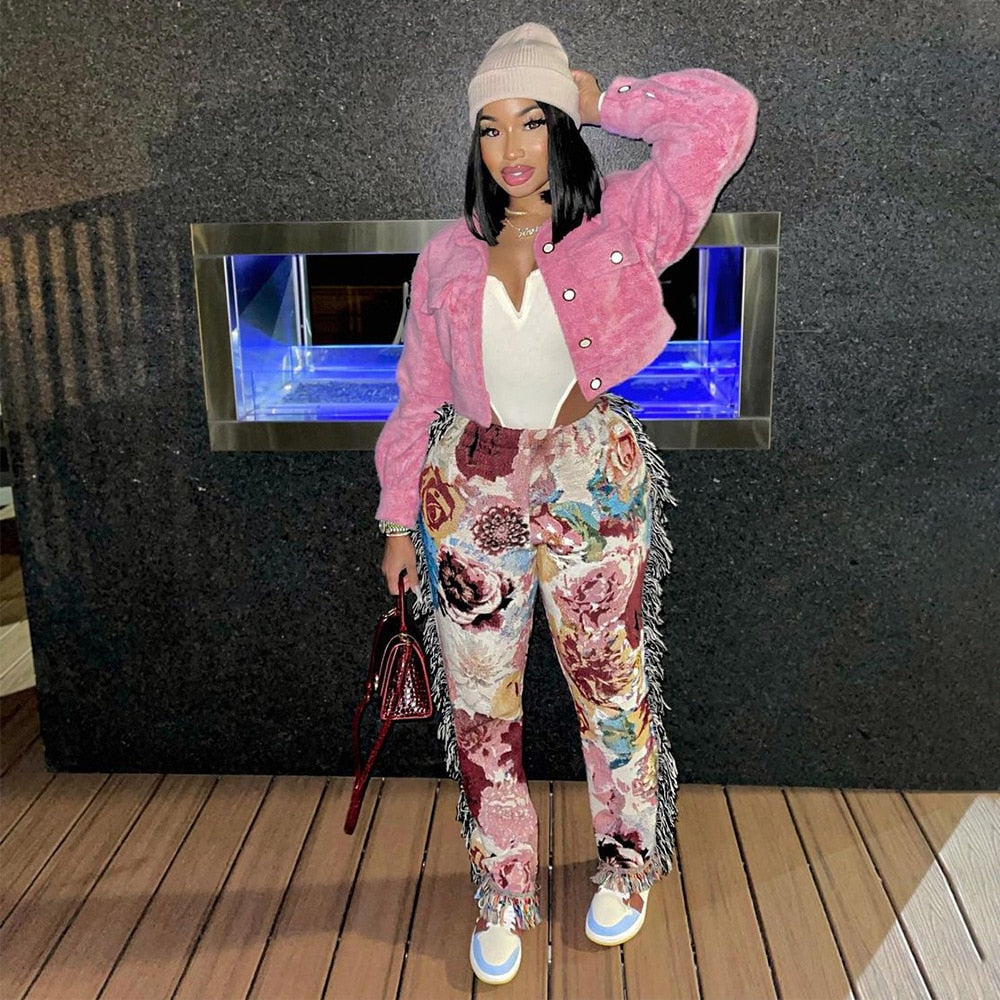 Woman wearing EtherealBe tassel patchwork striped pants with pink faux fur jacket white top beanie